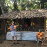 Tasting a delicious King coconut in a Village Fruit Stall